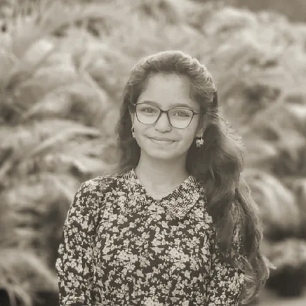 Laxmi Khengare, photographed outdoors against foliage.